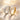 Silver and gold double-row stone-set band rings on satin fabric
