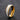 Gold double-row stone-set band ring standing on a dark textured surface