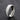 Silver double-row stone-set band ring standing on a dark textured surface