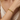 Pulsera dorada con placa ovalada grabada en la muñeca de una mujer