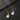 Collar dorado con dije de guitarra grabado con Forever y collar plateado grabado con Love You sobre fondo de pizarra oscura