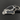 Close-up of custom engraved motorcycle keychain with a car key fob on a dark surface