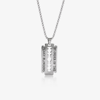 silver-tone razor blade shaped pendant with engraved text on a link chain necklace, on a light background