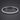 Silver-tone tennis bracelet with cubic zirconia and a fold-over clasp on a dark background