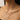 Model wearing layered gold-tone and silver-tone heart pendant necklaces