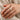 Double-row stone-set band ring worn on a finger