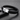 Black braided bracelet with a silver-tone engraved clasp on a dark surface