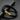 Black braided bracelet with a gold-tone clasp engraved with LOVE YOU on a dark surface