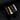 Black braided leather bracelets with gold-tone and silver-tone plates engraved DON'T LET THE HARD DAYS WIN
