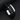 Close-up of a black braided leather bracelet with silver-tone clasp and engraved plate on a dark background