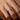 Hand wearing a silver-tone custom engraved open wrap ring with Love U text, close-up