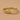 Gold-tone engraved open wrap ring with Forever heart text on a beige surface, close-up