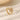 gold-tone open wrap ring with white marbled inlay on a cream surface